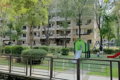a playground in a park with a building in the background at 2 Bedroom with Resort Facilities near BGC and Makati in Manila
