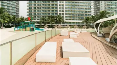 a row of white benches on the roof of a building at DT Suites and Resorts at Azure Paranaque in Manila