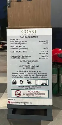 a sign for a parking garage with a parking meter at Coast Residences condo near MOA, StarCity and PICC in Manila