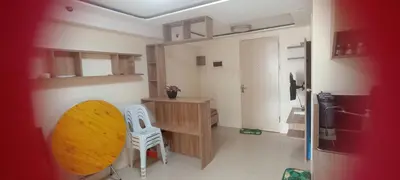 a kitchen with a table and two chairs in a room at Two bed room unit with parking space in Manila