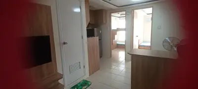 a hallway of a kitchen with a door to a room at Two bed room unit with parking space in Manila