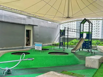 a playground in a building with green grass at BALAY MULANO at FAME RESIDENCES MANDALUYONG CITY l with balcony pool view l 200mbps wifi in Manila