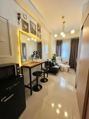 a living room with a table and a couch at HJ Maison in Manila
