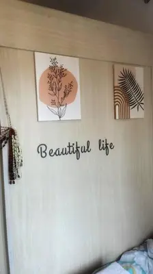 a bedroom with pictures on a wall with a bed at That Boho Crib 1bedroom with Balcony facing amenities in Manila