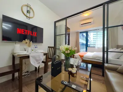 a living room with a couch and a table at 1BR Makati, Air Residences M008 in Manila