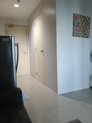 a room with a hallway with a door and a room with at Eriel condotel in Manila