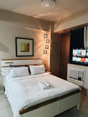 a bedroom with a large white bed in a room at The Serenity Studio in Manila