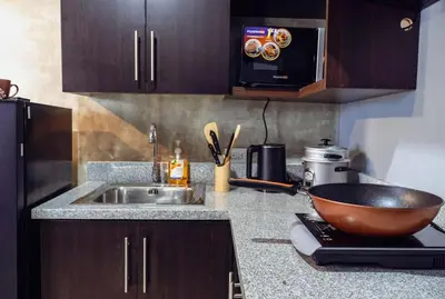 a kitchen with a bowl on a counter next to a sink at Comfy and Cozy Retreat in Manila with a Stunning View in Manila