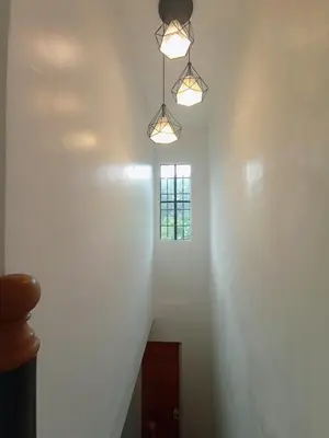 a stairway with two lights and a window at JeSa's Serenity Sanctuary in Dasmariñas
