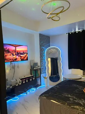 a bedroom with a bed and a tv on the wall at Affordable Azure Staycation in Manila