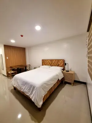 a bedroom with a large bed in a room at Flat 35, Unit 1E in Manila