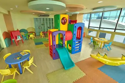 a play room with tables and chairs and a play structure at 1br wNetflix Disneyplus and pool across SM Megamall Ortigas CBD in Manila