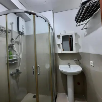 a bathroom with a shower and a sink at Quaint Aparthotel T22306 in Manila