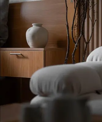 a white vase sitting on top of a wooden cabinet at Sarannya Home BGC in Manila