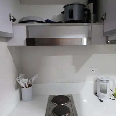a kitchen with a stove top oven in a kitchen at Air Residences - Panoramic City View near Airport - 4734 in Manila