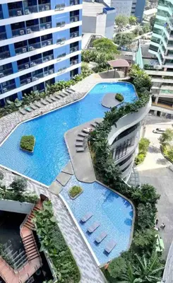 an aerial view of a building with two swimming pools at Air Residences - Panoramic City View near Airport - 4734 in Manila