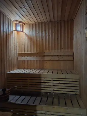 a wooden sauna with a bench in the middle at Minimalist and cozy place with balcony in Manila