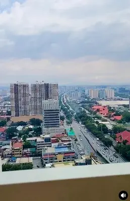 an aerial view of a city with buildings and traffic at Cosy Deluxe Flat with Balcony near MOA in Manila