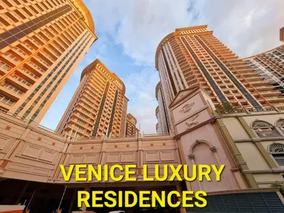 a group of tall buildings with the words venice luxury residences at Elegant Condo at Venice Grand Canal BGC #vlrtc27e in Manila