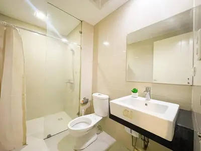 a bathroom with a toilet and a sink and a shower at Elegant Condo at Venice Grand Canal BGC #vlrtc27e in Manila