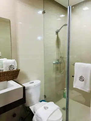 a bathroom with a shower and a toilet and a sink at Greenbelt Hamilton Tower 1 Legazpi Makati City - by ES Elite Suites in Manila