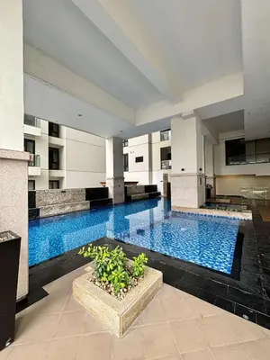 a large swimming pool in a building at Greenbelt Hamilton Tower 1 Legazpi Makati City - by ES Elite Suites in Manila