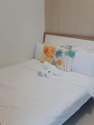 a white bed with two stuffed animals on it at Jazz stacation in Manila