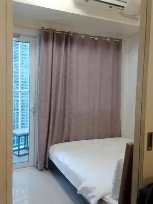 a bedroom with a bed and a window at Jazz stacation in Manila