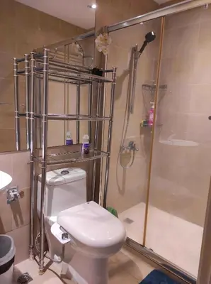 a bathroom with a shower and a white toilet at Newly Interiored 1 Bedroom with Balcony, City, Manila Bay and Sunset View with Netflix, Free Access to Infinity Pool, Gym, Sauna in Manila