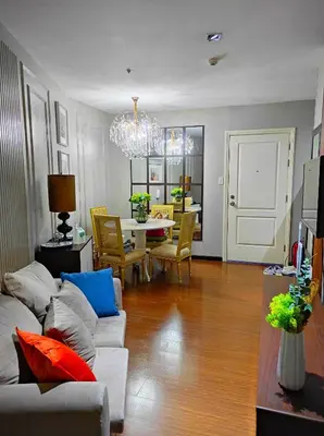 a living room with a couch and a table at Newly Interiored 1 Bedroom with Balcony, City, Manila Bay and Sunset View with Netflix, Free Access to Infinity Pool, Gym, Sauna in Manila