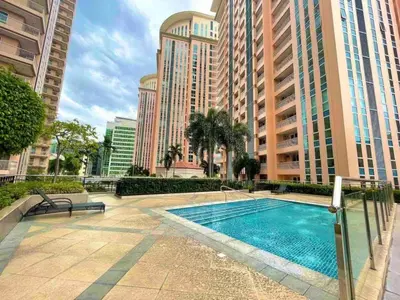 a swimming pool in a city with tall buildings at Modern BGC Stay at Venice Residences #vlrtc29h in Manila