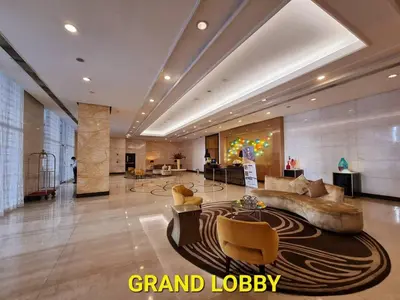 a lobby with a couch and chairs in a building at Modern BGC Stay at Venice Residences #vlrtc29h in Manila