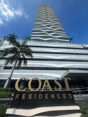 a tall building with a sign in front of it at Coast Residence Sea View Balcony Netflix WiFi Near MOA 3146 in Manila