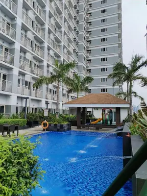 a large apartment building with a large swimming pool at Coast Residence Sea View Balcony Netflix WiFi Near MOA 3146 in Manila