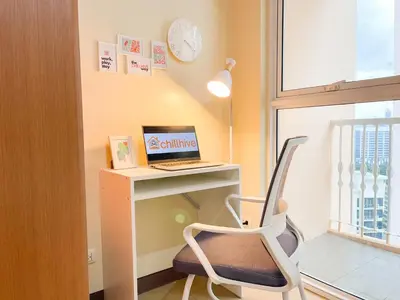 a room with a desk with a laptop and a chair at Cozy Condo in Venice BGC with balcony #vlrtc28C in Manila