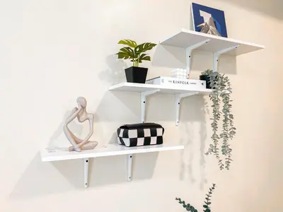 a white shelf hanging on a wall with plants at Best Staycation in BGC Central #aatft13j in Manila