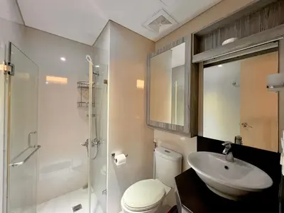 a bathroom with a toilet and a sink and a shower at 5Q Place Hotel Manila Airport in Manila