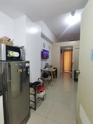a kitchen with a refrigerator and a dining room at Jazz Apartment Unit in Manila