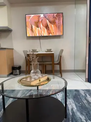 a glass table with a vase on top of it at Rustic Elegance New One Bedroom One Uptown Free parking in Manila