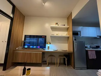 a desk with a computer on top of it in a kitchen at Heathers Crib In Ayala Makati City in Manila