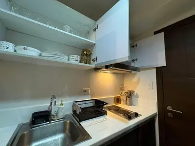a kitchen with a sink and a counter top at Heathers Crib In Ayala Makati City in Manila