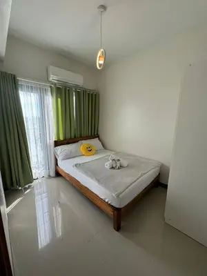 a bedroom with a bed with two stuffed animals on it at Bloom Residences by Casa Stellar in Manila