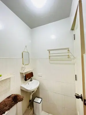 a white bathroom with a sink and a mirror at Fablo Getaway beside EK in Santa Rosa