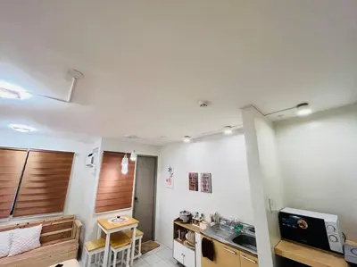 a kitchen with a sink and a table in a room at Fablo Getaway beside EK in Santa Rosa