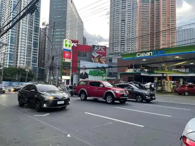 a busy city street with cars and buildings at 2BR-T31807 Sunshine100 Pool Billiard 70 inches TV Karaoke in Manila