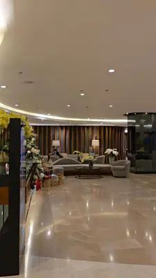 a lobby with a couch and a table in a building at Jay Suite in Manila