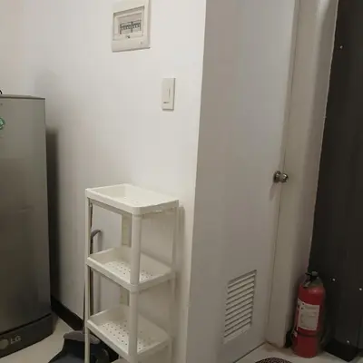 a white shelf in a room with a refrigerator at Birch Tower by the Bay Studio type in Manila
