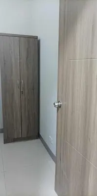 a room with a wooden door and a cabinet at Charlie's Penthouse in Mall of Asia Complex in Manila