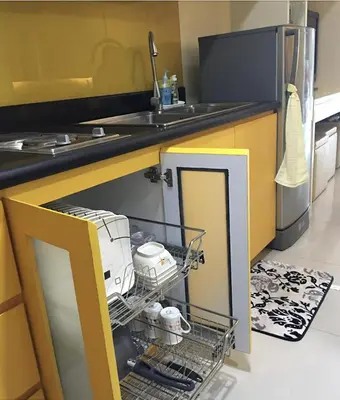 a kitchen with a dish drying rack with a appliance at Cozy 1BR Condo at SM Lights Mandaluyong City in Manila
