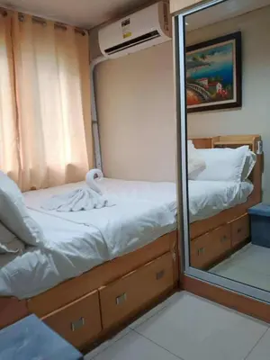 a mirror reflection of a bed in a small room at Dmjs staycation in Manila
